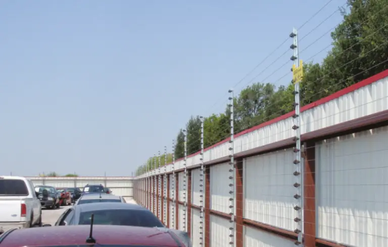Electric security fence installed on a perimeter wall for enhanced protection.